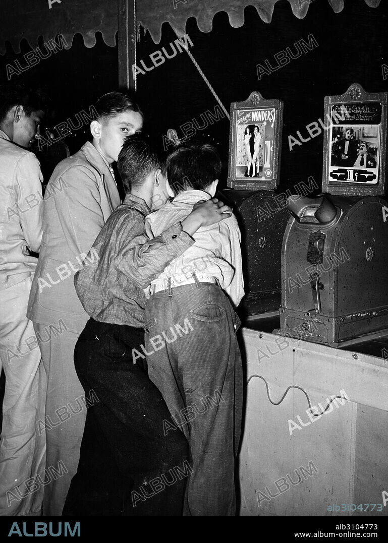 Young boys looking at nude dancer in the penny movies at south Louisiana state fair 1945.