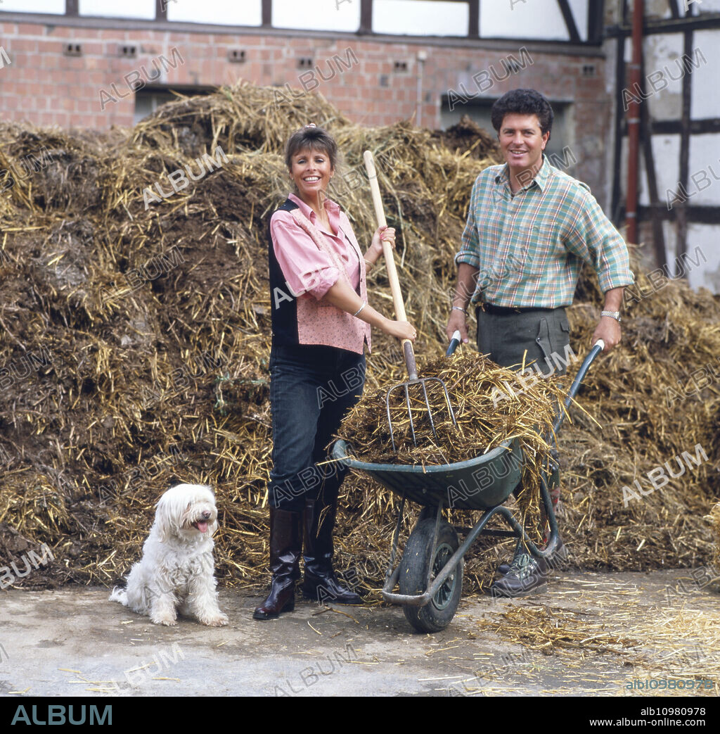 German-British pop singer Ireen Sheer poses with her husband Gavin du Porter on her farm in the early 1990s.