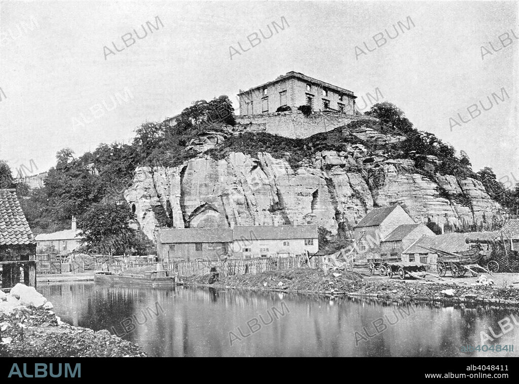 Nottingham Castle before restoration, Nottinghamshire, c1865. View showing Gordon's Wharf at a basin on the Nottingham Canal. After the restoration of King Charles II in 1660, title to Nottingham Castle passed to the Duke of Newcastle whose ambition was to erect a new and modern building. Although over 70 years old he began the project with enthusiasm. Every remaining stone of the old Castle was removed and several feet of rock itself cut away as a platform for the new house. The Duke only lived long enough to see the start of his mansion though his son carried it on to completion in 1679.  With the industrialisation of the town the mansion's attraction gradually diminished and by 1750 the Duke's visits had come to an end. Converting the building into apartments, the Duke rented them off to wealthy tenants. Later used as a boarding school, the mansion slowly declined and the gardens were let off as allotments. The last residents quit the building in 1829 and it remained unoccupied. The castle was set on fire in 1831 by pro-reform rioters and gutted. In 1859 the Town Council resolved that the Castle and its grounds would be an ideal site for a Museum of Fine Art and the Duke of Newcastle granted a lease of the Castle and its grounds for a term of 500 years. On 3rd July 1878 the Prince and Princess of Wales opened the first provincial Museum of Fine Art at Nottingham Castle. The photograph seen here was taken just before the castle was restored.