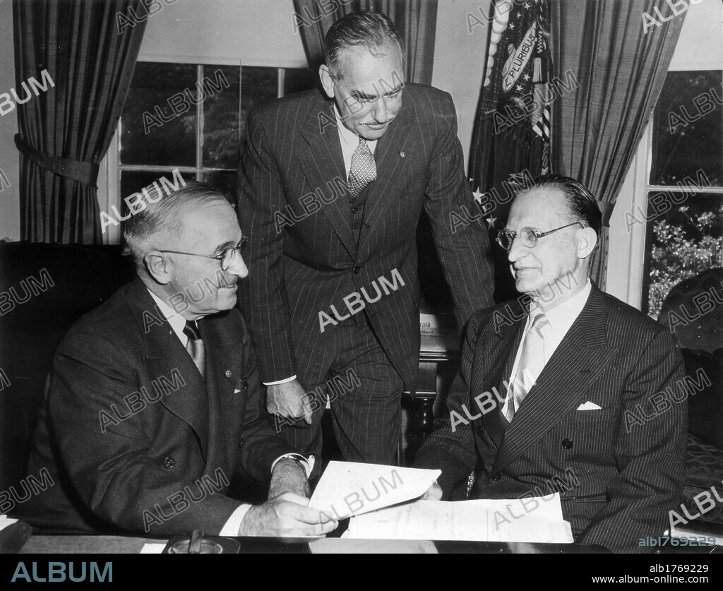 Alcide De Gasperi meeting Harry Truman. The Italian President of the Council Alcide De Gasperi sitting at a desk with the President of the United States of America Harry Truman and the Secretary of State Dean Acheson. USA, January 1947.