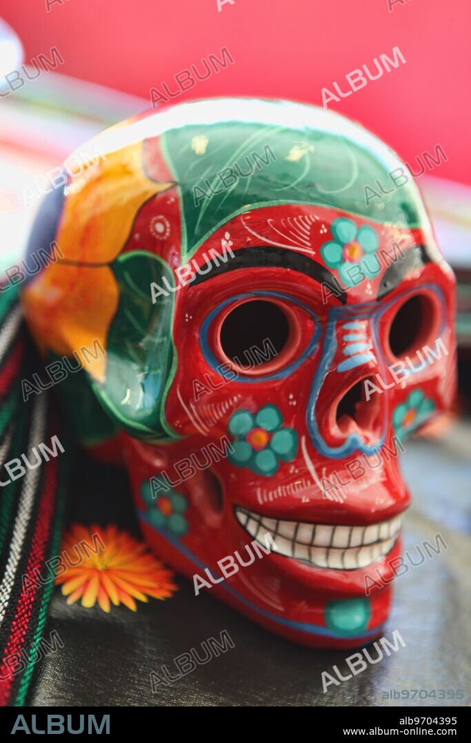 A colorfully painted skull on display during the Day of the Dead (Dia de los Muertos), a traditional Mexican holiday which coincides with All Souls Day in the Catholic calendar, is marked by visits to the grave sites of loved ones. It is a joyous occasion during which the celebrants remember the deceased.