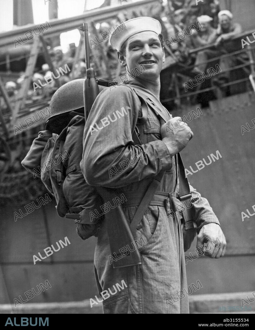 Davisville, Rhode Island:   December 26, 1943. This Navy Seabee is heading off for duty in the South Pacific. The Seabees were founded here two years ago on December 28, 1941, ready to work or fight or both.