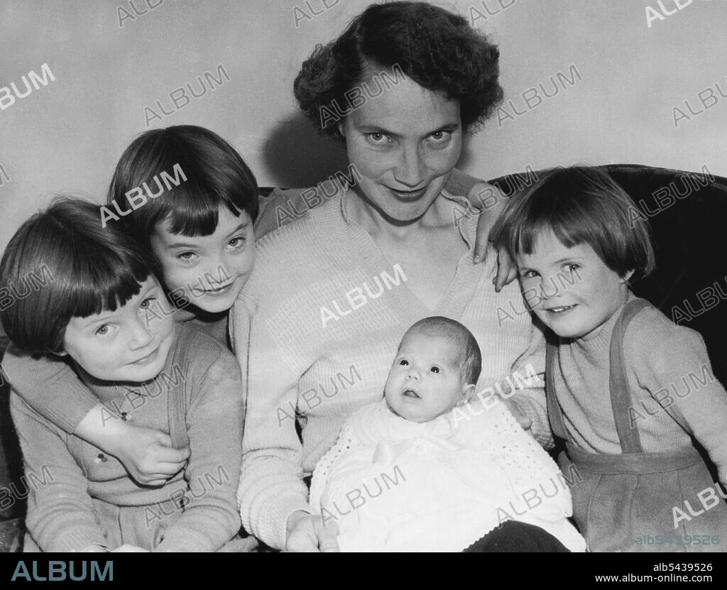 Mrs. Sneddon with Gregory and daughters Anice, Cheryl, Lana. Sisters love to mother him but still do so in a gingerly fashion.L To R: Anice (4), Cheryl (5) Mrs. James Sneddon, Son Gregory, Lane (3). September 28, 1953.