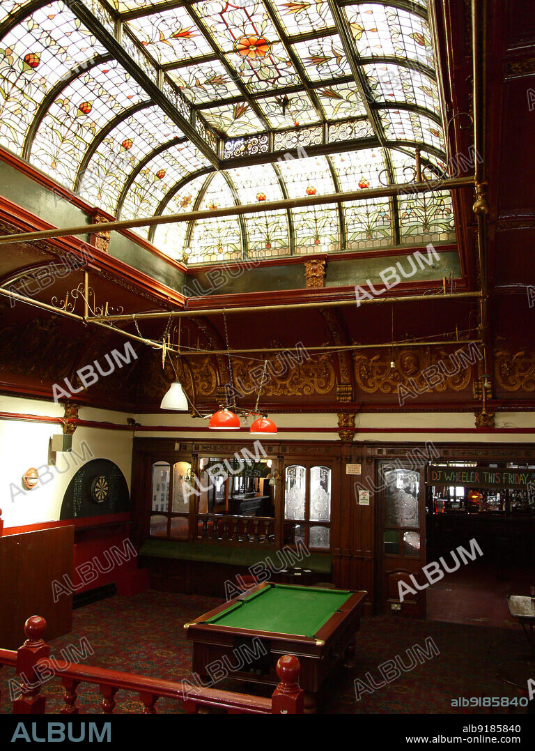 SIMON INGLIS. Boleyn Tavern, Barking Road, Barking, Newham, Greater London Authority, 2009. The billiard room in the Boleyn Tavern, Upton Park, with large painted roof light above a pool table. The Boleyn Tavern was built in 1899-1900 to the designs of WG Shoebridge and HW Rising. It is Grade II listed. The billiard hall was later converted into a dining room as part of restoration work in 2020-2021.