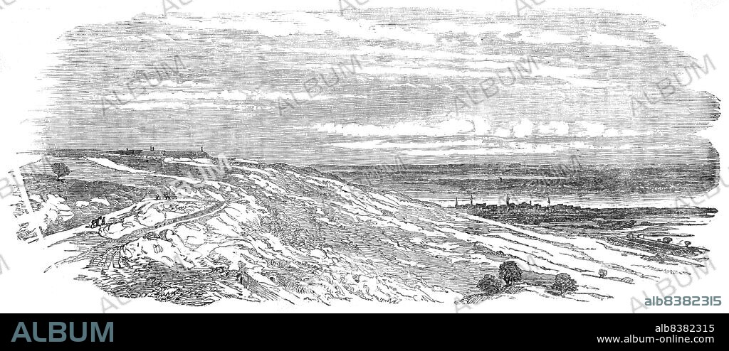 Arab Tabia and Islanli Tabia, Silistria, 1854. Crimean War. 'Interior of Arab Tabia, as it remains since the 25th of June, when the siege of Silistria was abandoned by the Russians...View of Arab Tabia and Illanli, from the Russian batteries on the left of the Turkish positions. Arab Tabia is on the left of the drawing, Illanli on the right, and Silistria in the distance. The covered-way of the Russians leads up from the left of the drawing, and turns from the vale up the sides, so as to be as much as possible out of the way of shells. The covered-way has little holes in the sides, where the Russians ensconced themselves. The two tunnel-like apertures are for cooking'. From "Illustrated London News", 1854.