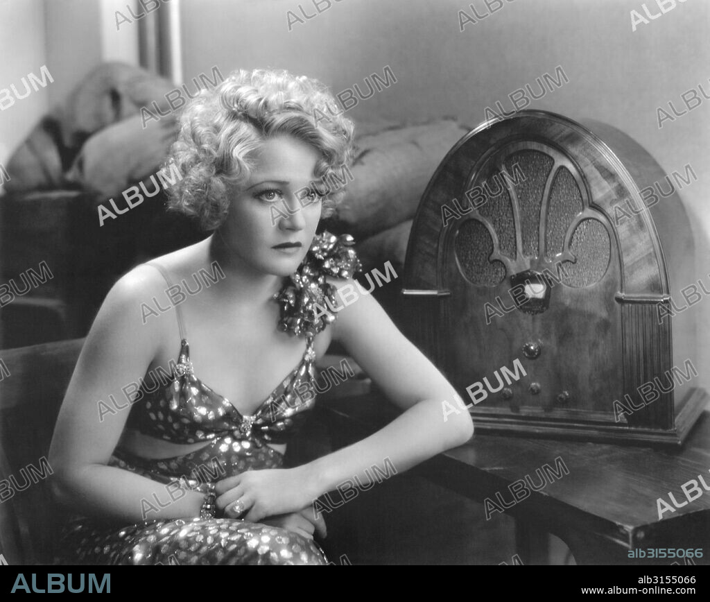 Hollywood, California:    1932 Actress Wynne Gibson listening to apparently bad news on the radio in the film, 'Lady And Gent'.