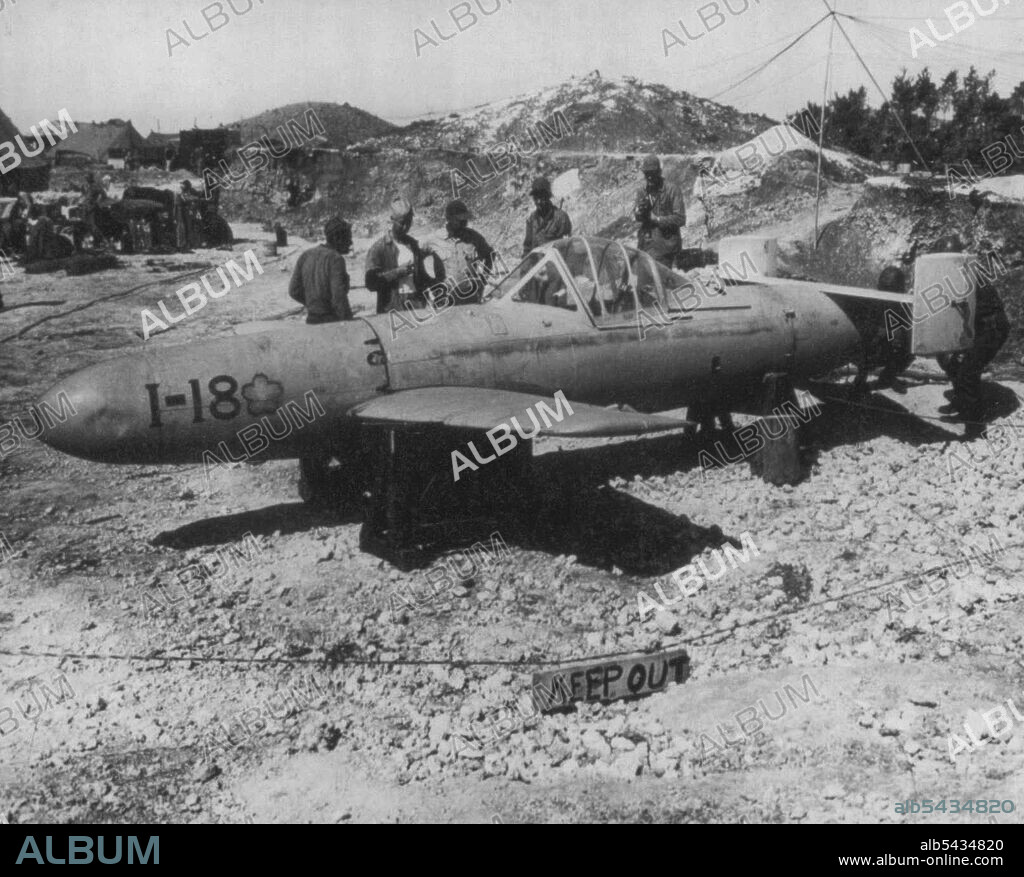 Marines Examine Jap 'Baka' bomb -- On Okinawa's Yontan airfield, warines examine an abandoned Jap "Baka" bomb. The weapon equipped with wings, fins and tail assembly, carries a lone pilot on a suicide mission. The Rocket - propelled bomb is launched from *****. June 11, 1945.