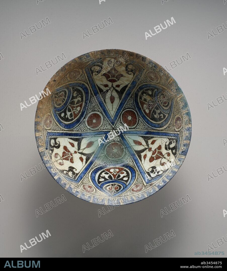 Bowl, late 12th–early 13th century, Made in Syria, probably Damascus, Stonepaste; polychrome painted under transparent glaze, Diam. 8 7/8 in. (22.5 cm), Ceramics, This bowl represents another innovation that coincided with the Syrian adoption of stonepaste: the application of pigment oxides directly on ceramic bodies before coating with transparent glaze. Often painted in radial designs, the colors included chromium black, copper turquoise, cobalt blue, and iron oxide red.