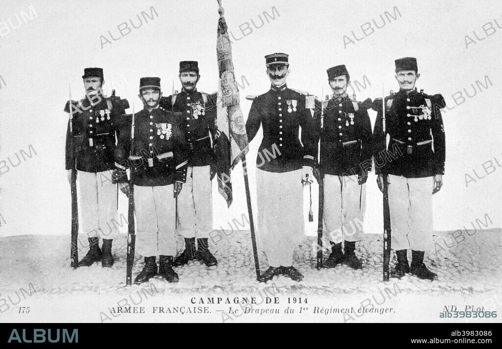 The flag of the 1st Regiment of the French Foreign Legion, 1914. The flag is inscribed with the names of battles in which the Legion fought, including Sevastopol (1855), Kabylia (1857), Magenta (1859) and Camaron (1863). French postcard.