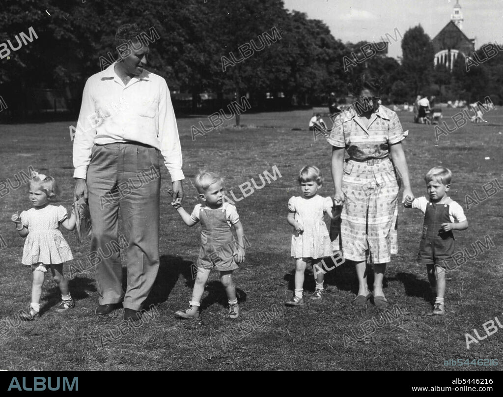 Quads Birthday -- The Sara quads of New South Wales who are in London paying a visit to their grandparents home in Chiswick, Lake are seen in Turnham Green Park watching the trains go by. From L to R they are Judith, Alison, Mark and Philip. August 17, 1953. (Photo by Daily Mail Contract Picture).