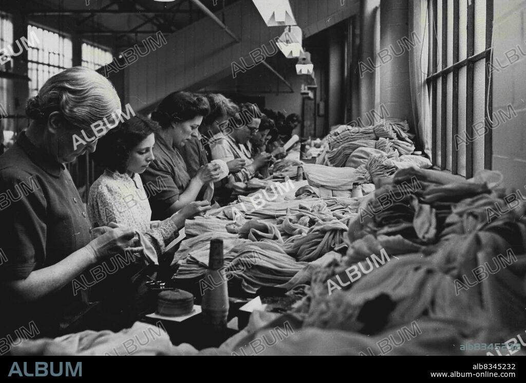 Nylon On The Way -- A busy scene in the Nottingham factory of I. & R. Morley. These workers make the final inspection of the finished nylons before they meet the dyeing process, and subject the stockings to a scientific rough-handling process knows as "scratching".Nylon stockings, so long awaited by the women of Britain, will be in the shops by Christmas. The hosiery industries, employing 60,000 workers, are engaged in an all-out drive to bring nylons in quantity to the market and supplies will begin to appear after December 1st. November 13, 1946. (Photo by Reuterphoto).