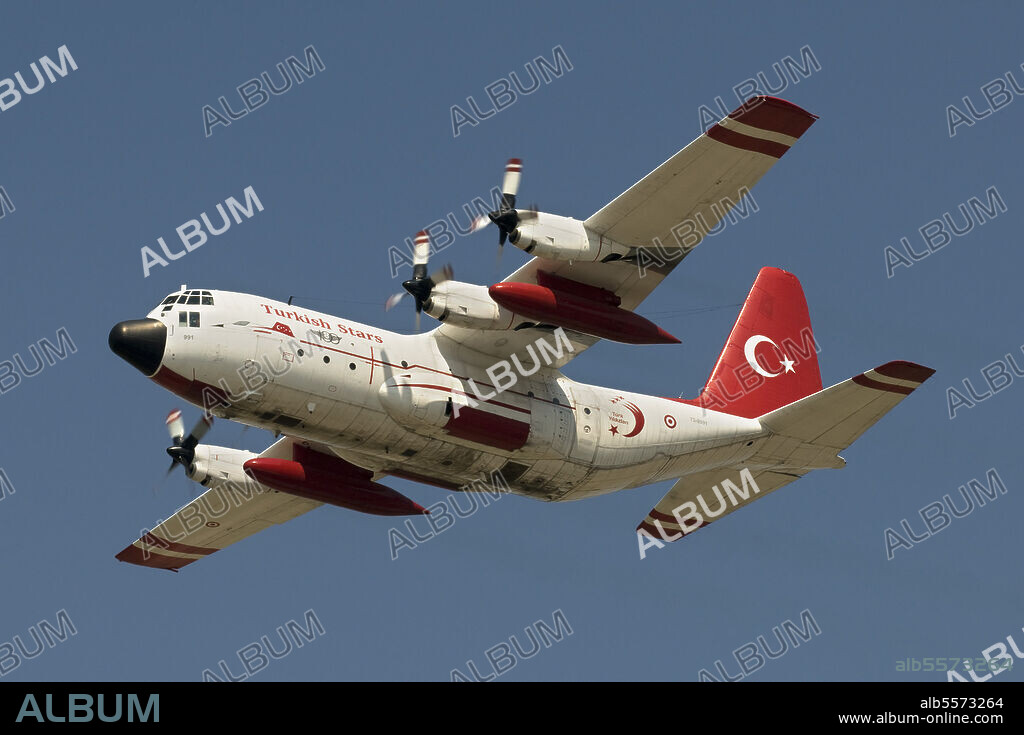 A Turkish Air Force C-130E Hercules wears the paint scheme of the Turkish Stars during a flypast over Izmir, Turkey, for the 100th Anniversary of the Turkish Air Force.