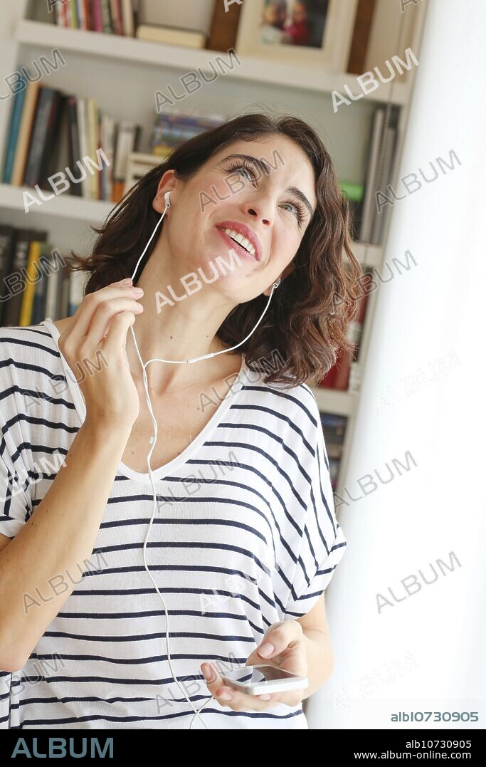 Woman listening music with Smartphone.