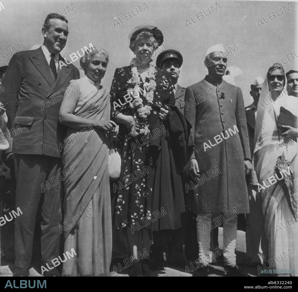 Indian Welcome For Mrs. FDR - A welcoming garland of blossoms adrons the neck of Mrs. Elanor Roosevelt as she is welcomed to New Delhi by members of India's first family last week. In group at the capital city's airport are (left to right) U.S. Ambassador to India Chester Bowles; Madame Pandit, former Indian ambassador to U.S.; Mrs. Roosevelt; Premier Jawaharlal Nehru; and Rajkumari Amrit Kaur the Premier. Mrs. Roosevelt, who previously had visited Pakistan, denied that the visit had any political significance. March 2, 1952. (Photo by AP Wirephoto).