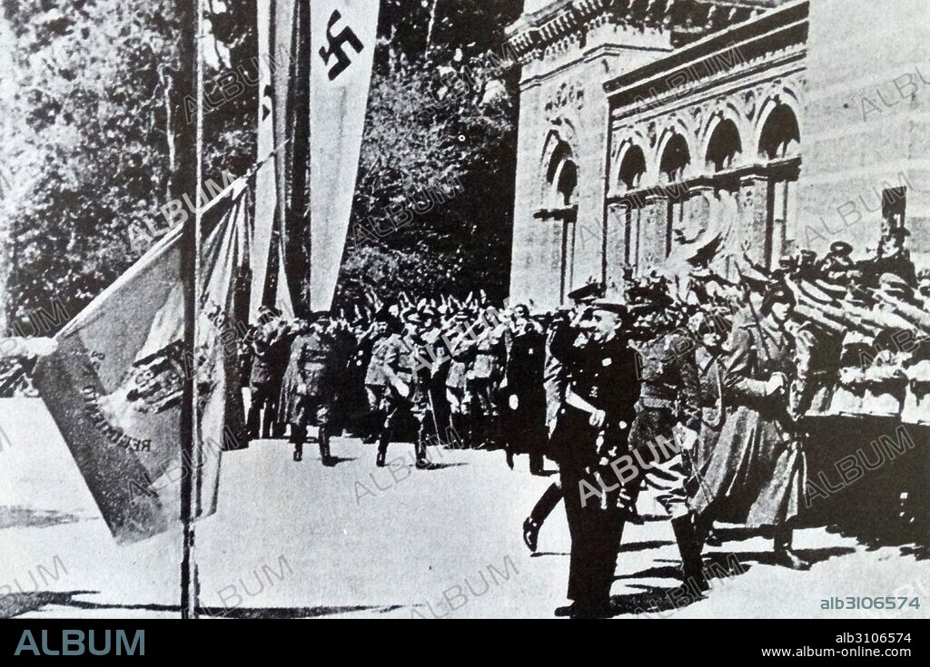 General Franco takes the salute at a parade while German soldiers look on during the Spanish Civil War.