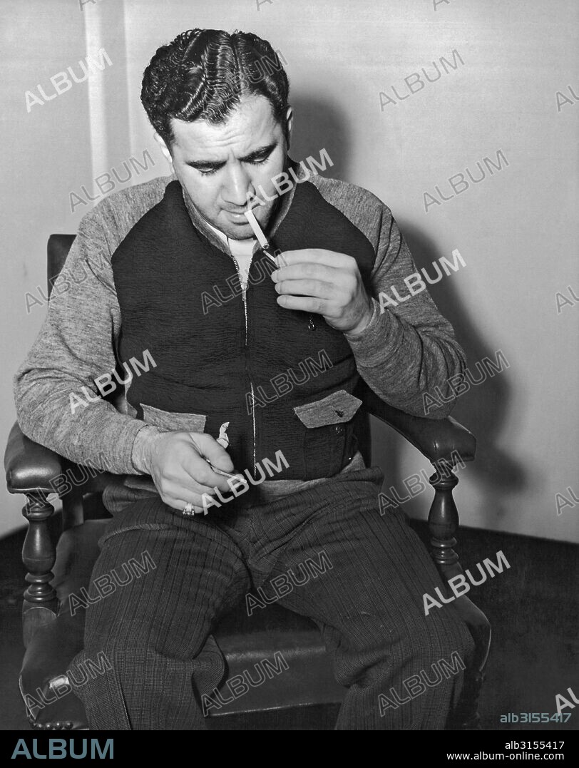 New York, New York: 1940. Abe Reles (Kid Twist) lighting a cigarette at the District Attorney's office in Brooklyn. He was considered the most feared hit man for Murder, Inc., but turned state's evidence when implicated in several murders.