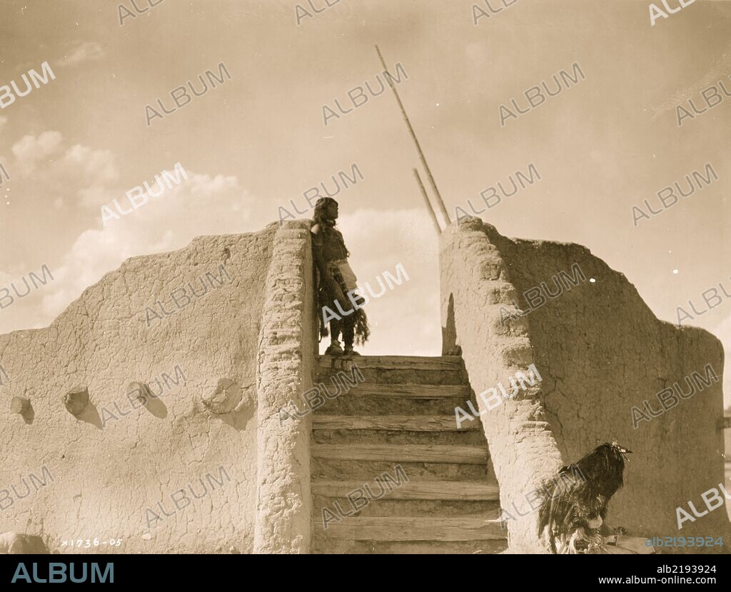 Tewa Indian guard at top of the kiva stairs, San Ildefonso, New Mexico.