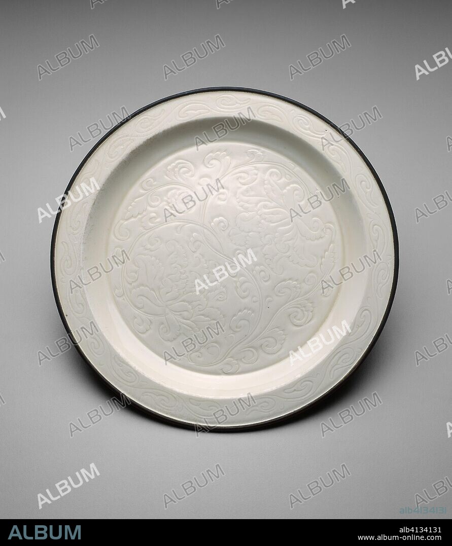 Shallow Dish with Peony Sprays. China. Date: 1000-1099. Dimensions: H. 2.3 cm (15/16 in.); diam. 24.9 cm (9 13/16 in.). Ding ware; porcelain with underglaze carved decoration; metal rim. Origin: China.