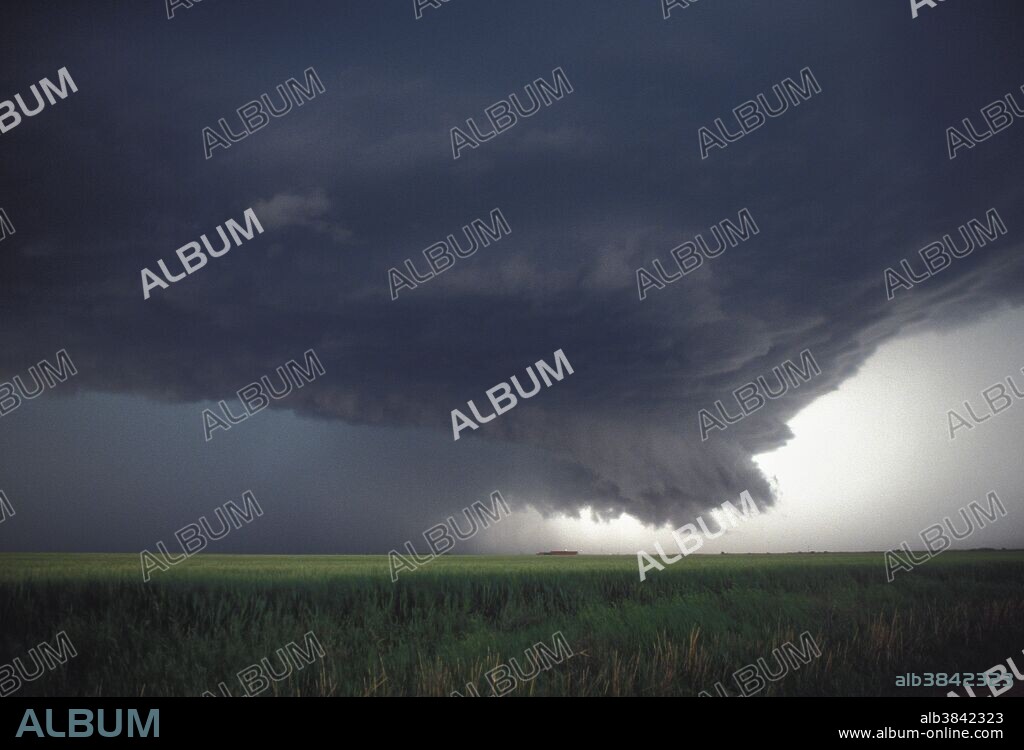 Dangerous mesocyclone of a supercell thunderstorm that produced softball-sized hail near Altus, Oklahoma during the evening of April 18, 1992. Mesocylones are most commonly observed in supercell thunderstorms with a mix of warm updrafts and cold downdrafts, often producing hail. Supercells or rotating thunderstorms usually have a flared or bell-shaped cloud base and are sometimes associated with tornadoes. They occur commonly in the Great Plain states with a counter-clockwise rotation.