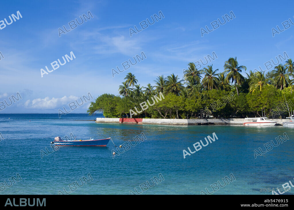 Asia's smallest and least-known nation, the Republic of Maldives, lies scattered from north to south across a 750-kilometre sweep of the Indian Ocean 500 kilometres south-west of Sri Lanka. More than 1000 islands, together with innumerable banks and reefs, are grouped in a chain of nineteen atolls which extends from a point due west of Colombo to just south of the equator. The atolls, formed of great rings of coral based on the submarine Laccadive-Chagos ridge, vary greatly in size. Some are only a few kilometres square, but in the far south the great atoll of Suvadiva is sixty-five kilometres across, and has a central lagoon of more than 2000 square kilometres. The northern and central atolls are separated from each other by comparatively narrow channels of deep water, but in the south Suvadiva is cut off by the eighty-kilometre-wide One-and-a-half-Degree Channel. Addu Atoll is still more isolated, being separated from the atoll of Suvadiva by the seventy-kilometre-wide Equatorial Channel.