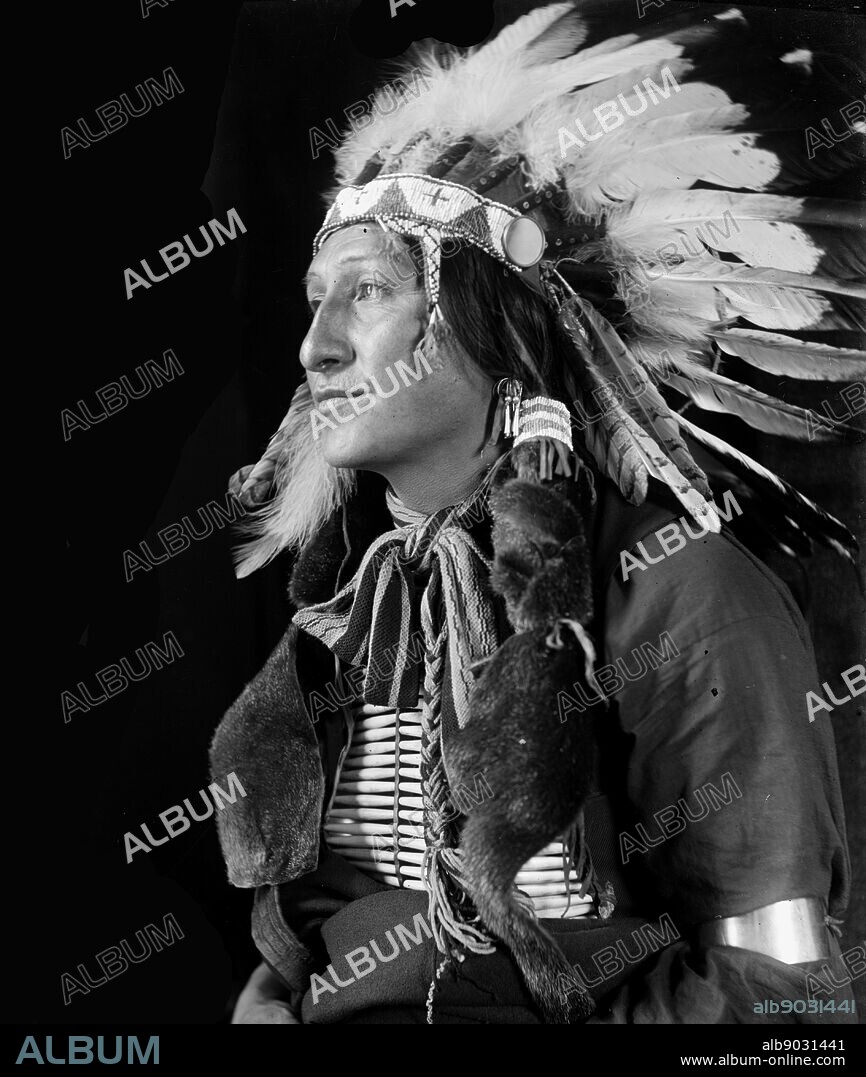 Joe Black Fox by Photographer Gertrude Käsebier, 1852-1934. Sioux Indian from Buffalo Bill's Wild West Show. Joe Black Fox, half-length portrait, seated, facing left. Dated ca. 1900.
