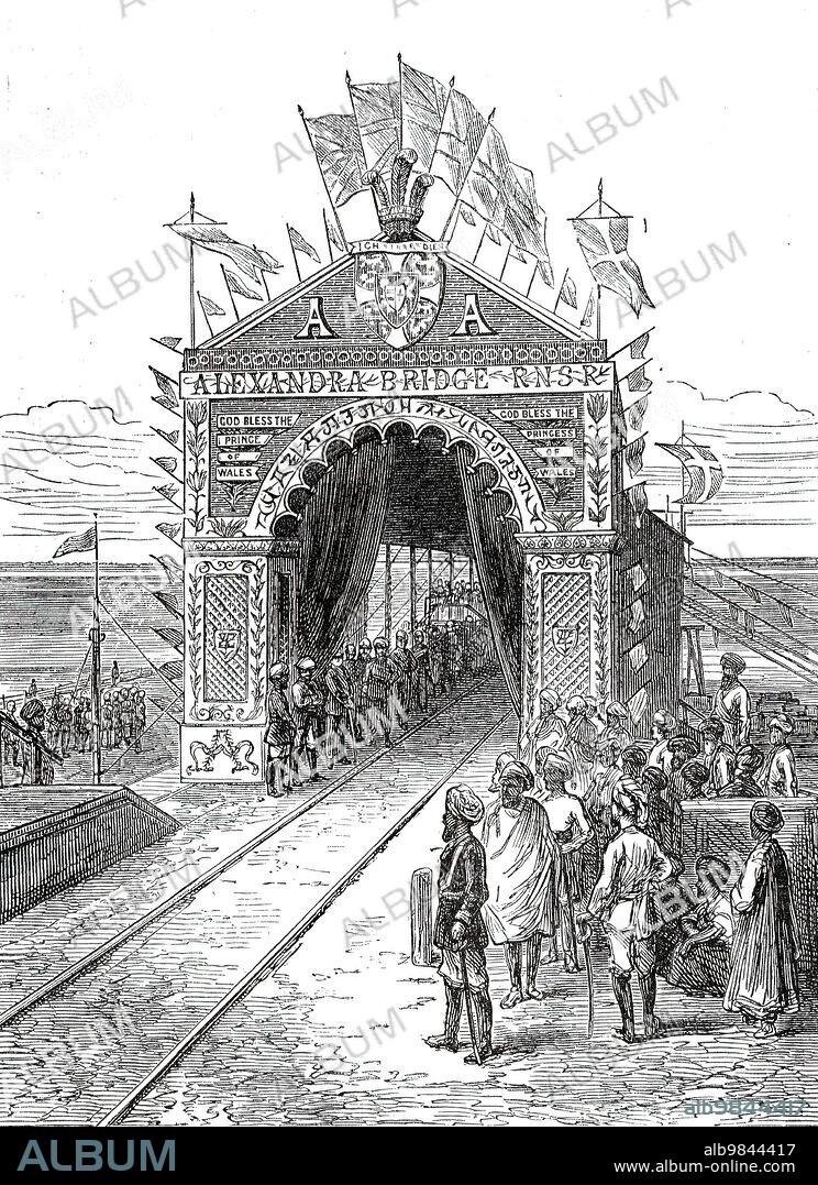 Triumphal Arch on the Alexandra Railway Bridge at Wuzeerabad, from a sketch by one of our special artists,  1876. 'The Prince [of Wales, future King Edward VII) was accompanied by some of the Maharajah's courtiers and nobles...proceeded to Wuzeerabad [Wazirabad], where the Prince was to perform the ceremony of completing and opening the "Alexandra" bridge of the Punjaub Northern State Railway. This railway-bridge over the Chenab has been constructed under the superintendence of Mr. Alexander Grant, C.E., engineeer-in-chief, and Mr. Henry Lambert, executive engineer. It was commenced in November, 1871, and is a very great work of its kind, being 9300ft. long, in 61 spans, with foundations 70 ft. deep: it is said to be the longest bridge in the world'. From "Illustrated London News", 1876.