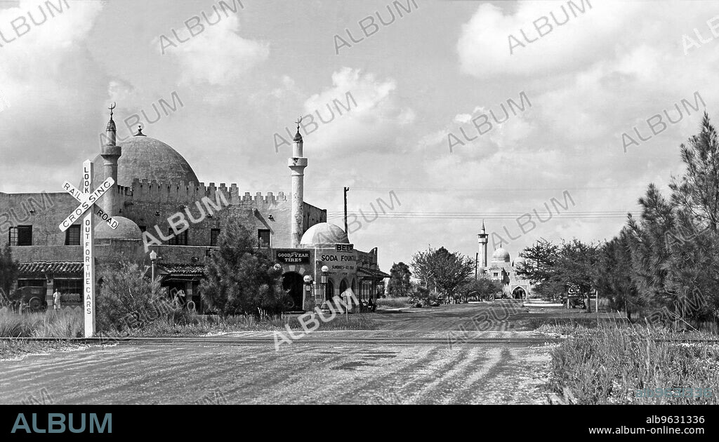 Opa Locka, Florida, February 26, 1935 Entering Opa Locka from the south. The building at left houses the grocery store, garage, drug store, and post office. The British American Cinema Studies building is in the distance. Opa Locka is a suburb of Miami that has a Moorish look to the architecture here. The town was founded by aviation pioneer Glenn Curtis in 1928 and was based on the Arabian Nights theme.