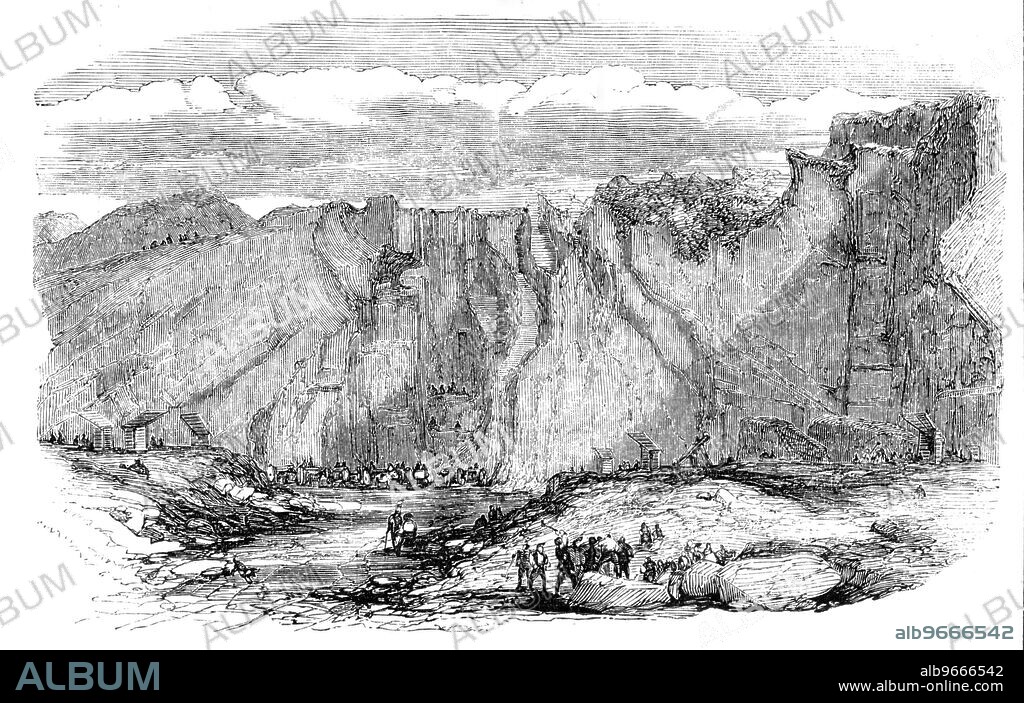 The Granite Quarries at Rubislaw, near Aberdeen, [Scotland], 1857. 'The pavement of London, extending through more than 5000 streets, and exceeding 2000 miles in length, is one of our metropolitan marvels; and we rarely see a street area broken up for repair without being reminded how vast are the operations by which the materials are brought from comparative solitudes to be strewed over the busiest haunt of man...One of the vast natural depots is the granite quarries at Rubislaw (pronounced Robsley), within a mile of Aberdeen, which is mostly built of it, and is hence called "the Granite City"...The area already worked is several acres in extent; and from these quarries is procured the grey granite, called Aberdeen granite...Rubislaw quarry is wrought by Messrs. John Gibb and Son, civil engineers, who are engaged in the pavement trade...'. From "Illustrated London News", 1857.