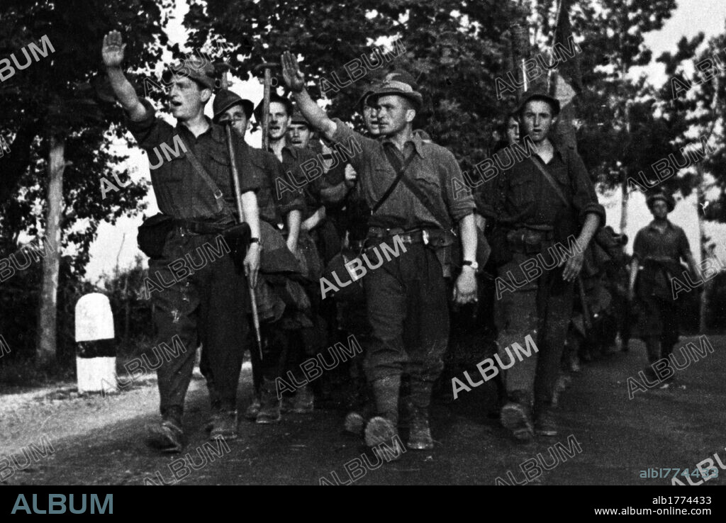 Soldiers of the Italian Alpine troops marching. The fourth regiment of the 'Littorio' Division marching and making the Roman salute. Italy, August 1944.