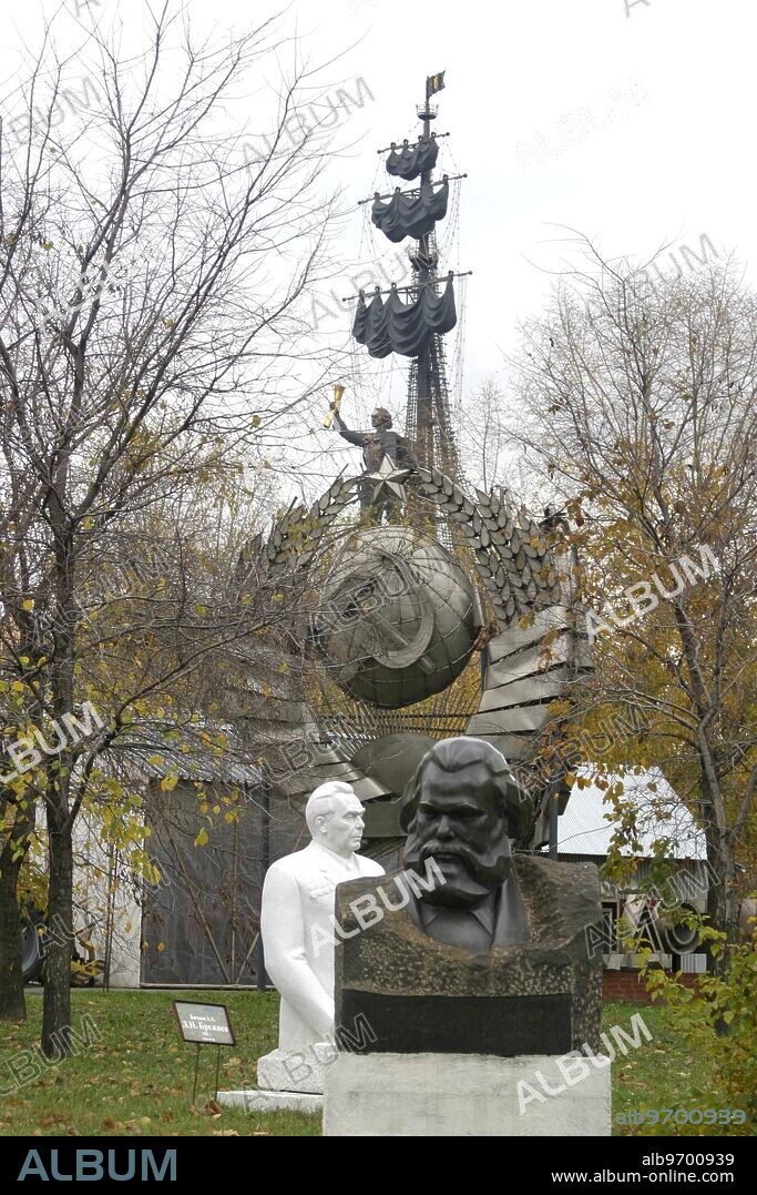 Gorky park sculpture garden containing many sculptures of soviet communist USSR. Peter the Great monument in background. Moscow. Russia.