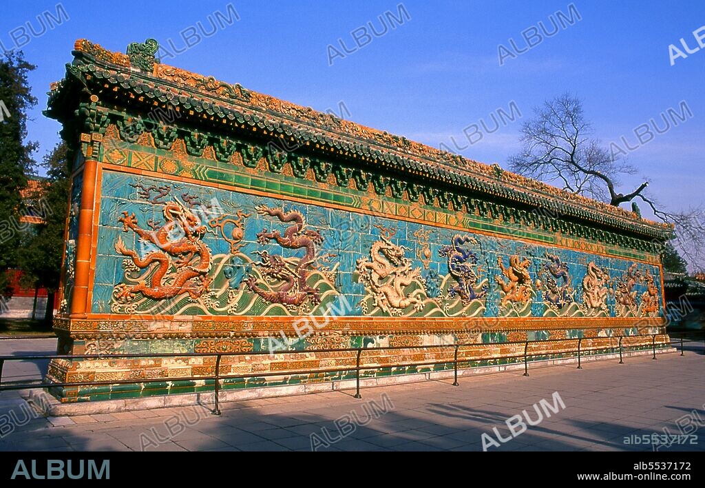 The Nine Dragon Screen, dating back to 1417, is an 87-foot wall decorated with glazed tiles showing nine dragons chasing a pearl in clouds above waves.