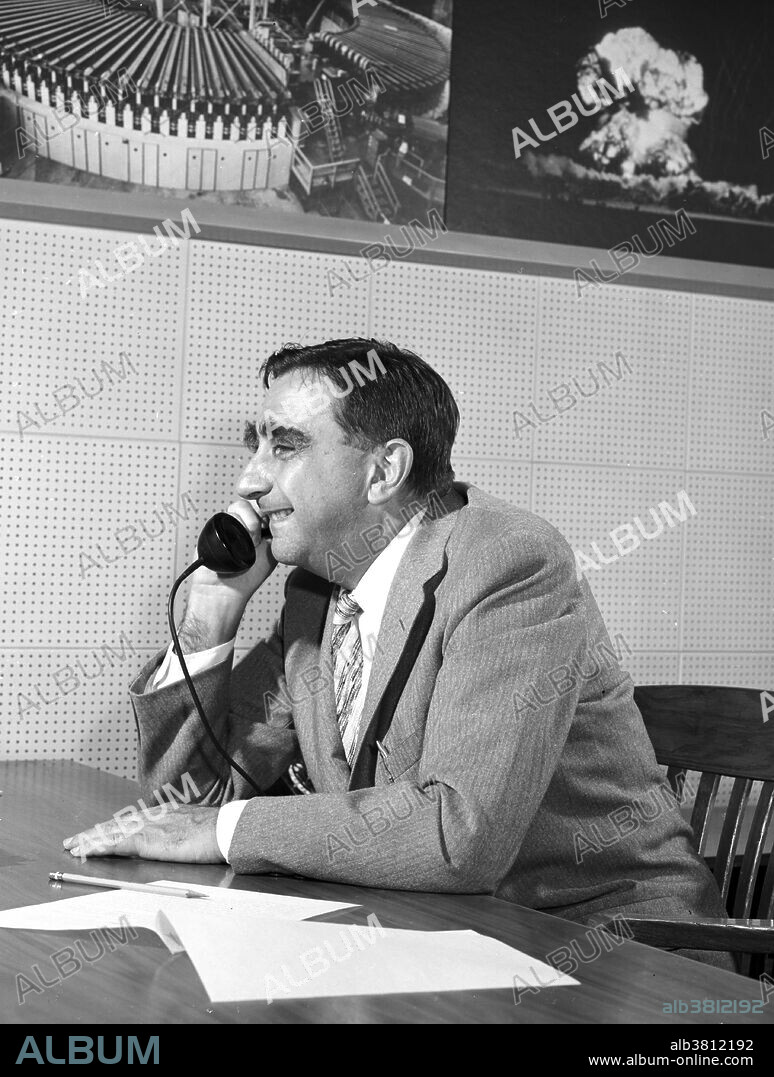 Teller at desk talking on telephone, 1958. Edward Teller (January 15, 1908 - September 9, 2003) was a Hungarian-born American theoretical physicist, known as "the father of the hydrogen bomb". He immigrated to the U.S. in the 1930s, and was an early member of the Manhattan Project charged with developing the first atomic bombs. During this time he made a serious push to develop the first fusion-based weapons as well, but these were deferred until after WWII. After his controversial testimony in the security clearance hearing of his former Los Alamos colleague J. Robert Oppenheimer, Teller was ostracized by much of the scientific community. He continued to find support from the U.S. government and military research establishment, particularly for his advocacy for nuclear energy development, a strong nuclear arsenal, and a vigorous nuclear testing program. He was a co-founder of Lawrence Livermore National Laboratory (LLNL), and was both its director and associate director for many years. He made numerous contributions to nuclear and molecular physics, spectroscopy and surface physics. Throughout his life, Teller was known both for his scientific ability and his difficult interpersonal relations and volatile personality. He died in 2003, at the age of 95.