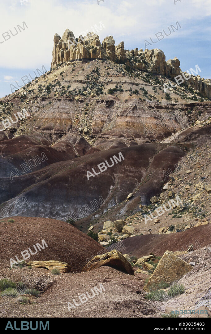The Circle Cliffs, along the Burr Trail in Grand Staircase Escalante National Monument, Utah, appear to watch over the dry pinyon-juniper forest below.
