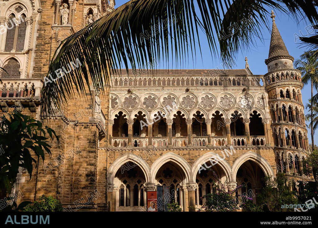 India: Partial view of the Rajabai Clock Tower (left) and the university library, Mumbai University, Mumbai, two of the numerous colonial-type ('Bombay Gothic') buildings in Fort and Colaba areas of the city. The University of Bombay, as it was originally known, was established in 1857. The Rajabai Tower and Library building were designed by Sir George Gilbert Scott and completed in 1878.