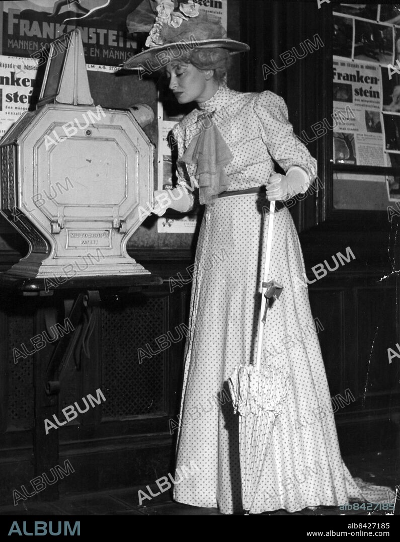 ARKIV 1949 - Bonnierarkivet. Skådespelerskan Gudrun Brost framför ett mutoscope, ett tittskåp med rörliga bilder, i Birger Jarlspassagen i Stockholm.. Foto: Arne Schweitz Kod: 1049. COPYRIGHT SCANPIX SWEDEN.