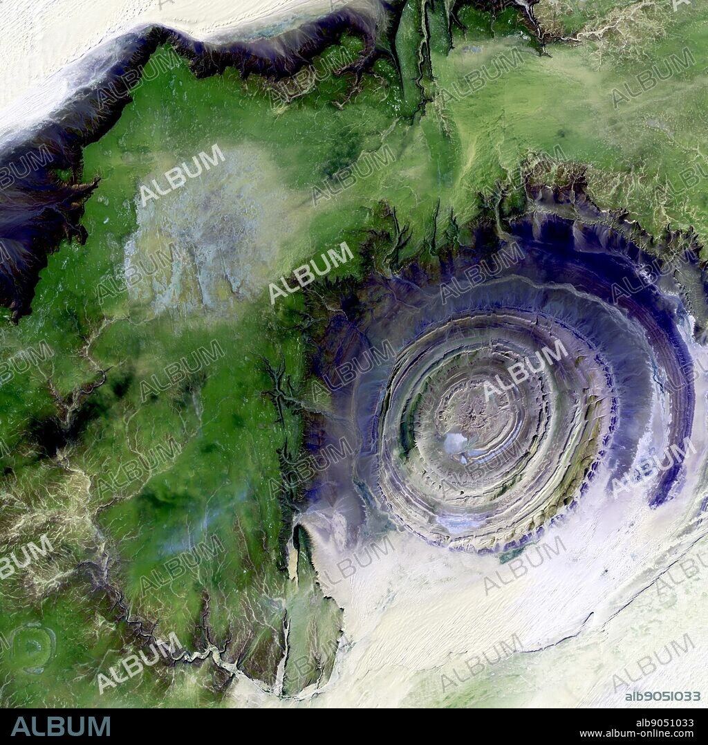The so-called Richat Structure is a geological formation in the Maur Adrar Desert in the African country of Mauritania. Although it resembles an impact crater, the Richat Structure formed when a volcanic dome hardened and gradually eroded, exposing the onion-like layers of rock. 2001.