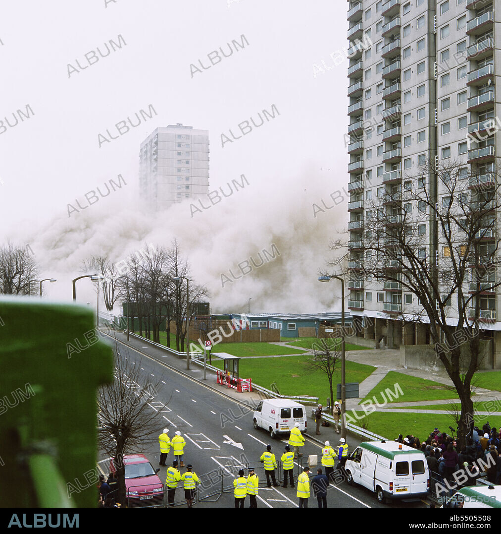 JOHN LAING PLC. Holly Street Estate, Dalston, Hackney, London, 24/03/1996. A view of tower blocks on the Holly Street Estate, showing a cloud of dust caused by the demolition of Rowan Court at the centre of the group. Laing Homes Special Projects worked in partnership with Hackney Council and a consortium of housing associations to redevelop the estate which had originally been built in the 1970s. The aim of the project was to provide over 1000 new and refurbished homes over a 6 year period, following traditional street patterns and providing gardens for residents. This photograph is part of a batch taken to show the demolition of Rowan Court which took place on 24th March 1996.
