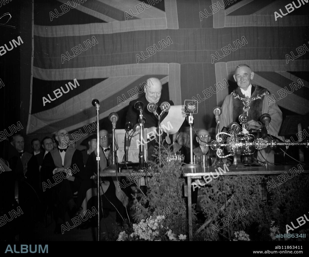 WINSTON CHURCHILL MADE FREEMAN OF PORTSMOUTH. Mr Winston Churchill beams as he follows the Lord Mayor of Portsmouth, Alderman Sir Denis Daly to the dais at South Parade Pier Pavilion, Portsmouth, to receive the Freedom of the City today. The scroll of freedom was contained in a casket of words from Nelsons flagship ' Victory'. 10 December 1950.