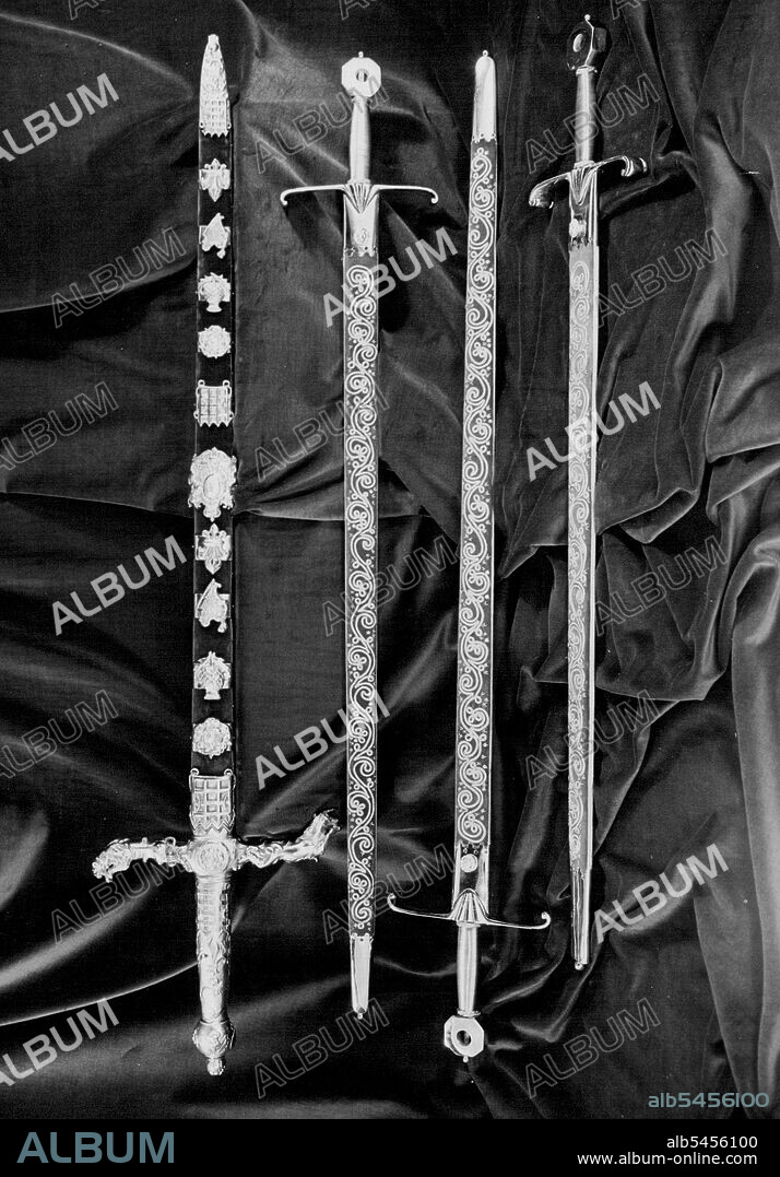 (Top to Bottom) The Sword of state
The Sword of spiritual justice
The Sword of Temporal justice
The Sword of Mercy (Known as Curtana)
The Sword of State is in two-handed sword, the length of the blade being 35 inches. The handle is of gilt metal, the cross-pieces representing the lion and the unicorn. The scabbard is decorated with diamonds, rubies and emeralds in designs of the Rose, the thistle and the Shamrock. At the Coronation the Peer who carries the Sword of State delivers it up to the Lord Champion who, in exchange, gives him the Jewelled Sword. December 03, 1952.