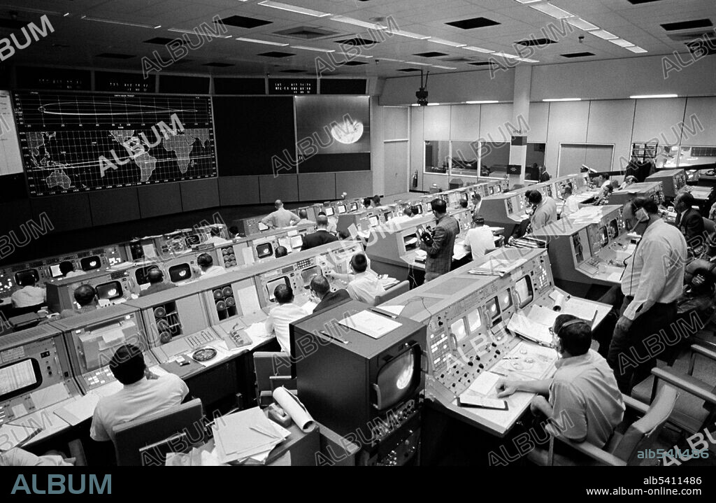 Overall view of the Mission Operations Control Room in the Mission Control Center, Building 30, on the third day of the Apollo 8 lunar orbit mission. Seen on the television monitor is a picture of Earth which was telecast from the Apollo 8 spacecraft 176,000 miles away.  December 23, 1968.