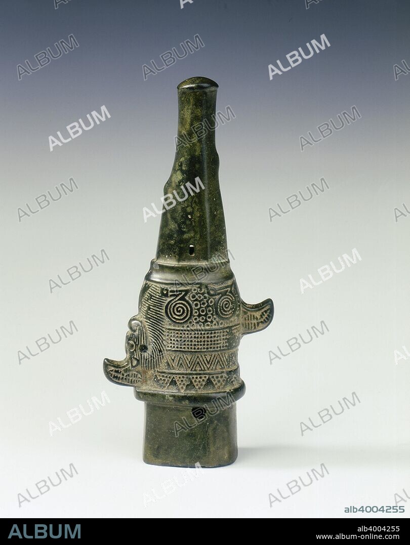 Bronze ferrule with sphinx-like animal, Eastern Zhou dynasty, China, 5th century BC. A bronze ferrule to cap the lower end of a weapon shaft and tip. There is a crouched creature, which looks somewhat sphinx-like, such as is found on Iranian metalwork and sculpture. The long neck carries striations as fur, and the legs have circular decorations reminiscent of patterns found on some early Ordos pieces. The spare space is filled with small geometric patterns. There are cowrie patterns on the tail and crest. The cowrie motif, though found in the art of several states, was a motif particularly popular in the western State of Jin.