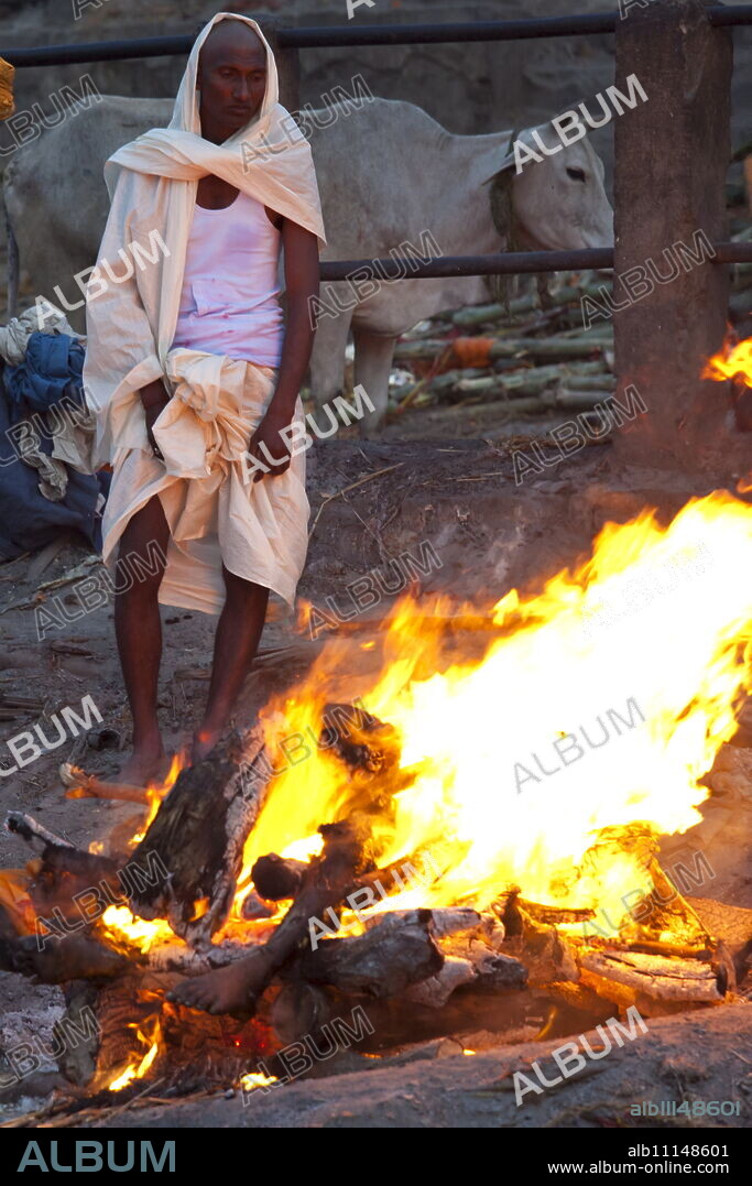 Body burning on funeral pyre at Hindu cremation at Manikarnika crematorium Ghat in Holy City of Varanasi, Benares, India.