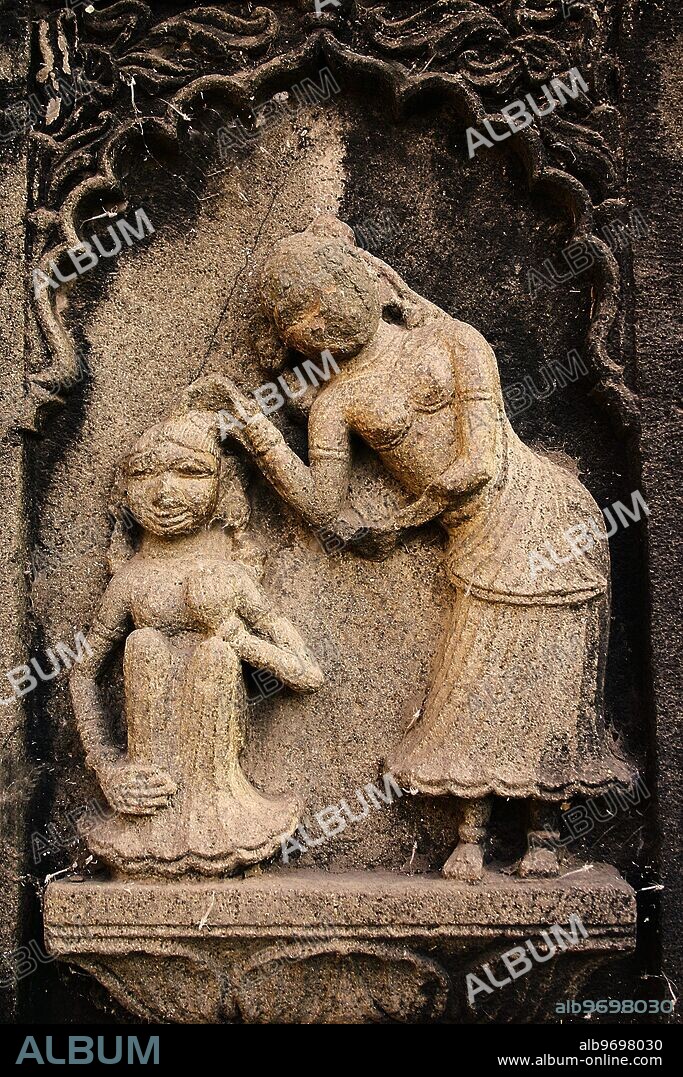 RSC75063 : Mother and daughter, carved on the wall of Ahilyabai temple, ornamental carving over stone, old Indian sculpture, Heritage site, in building on Ahilyabai ghat of Narmada river, was named after Ahilyabai, one of the most powerful ruler of Holkar dynasty of Indore, Maheshwar, Madhya Pradesh, India. -.