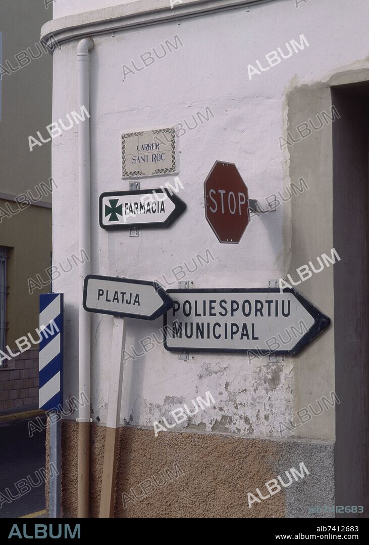ESQUINA CON CARTELES INDICATIVOS,SEÑAL DE TRAFICO"STOP" Y PLACA DE LA CALLE"CARRER SANT ROC".