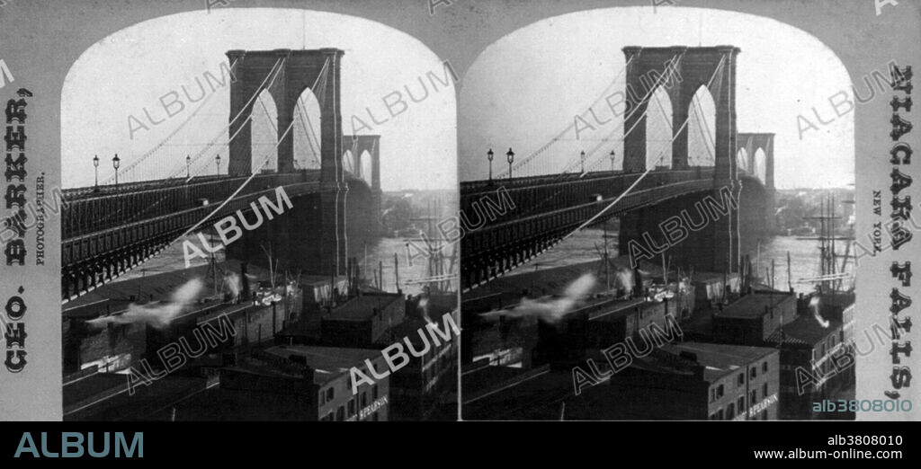 Stereograph card of Brooklyn Bridge, photographed by George Baker, 1888. The Brooklyn Bridge is one of the oldest suspension bridges in the United States. Completed in 1883, it connects the boroughs of Manhattan and Brooklyn by spanning the East River. With a main span of 1,595.5 feet, it was the longest suspension bridge in the world from its opening until 1903, and the first steel-wire suspension bridge. Originally referred to as the New York and Brooklyn Bridge and as the East River Bridge, it was formally named he Brooklyn Bridge by the city government in 1915. Since its opening, it has become an icon of New York City, and was designated a National Historic Landmark in 1964 and a National Historic Civil Engineering Landmark in 1972.