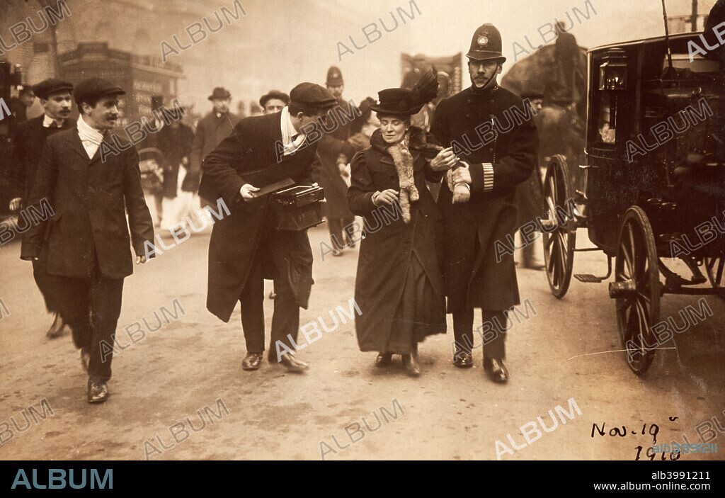 Suffragette being arrested, 19th November 1910. A tall policeman leads a rather shorter suffragette away, holding on to her arm. Many suffragettes were imprisoned and force-fed during their struggle to win the vote.