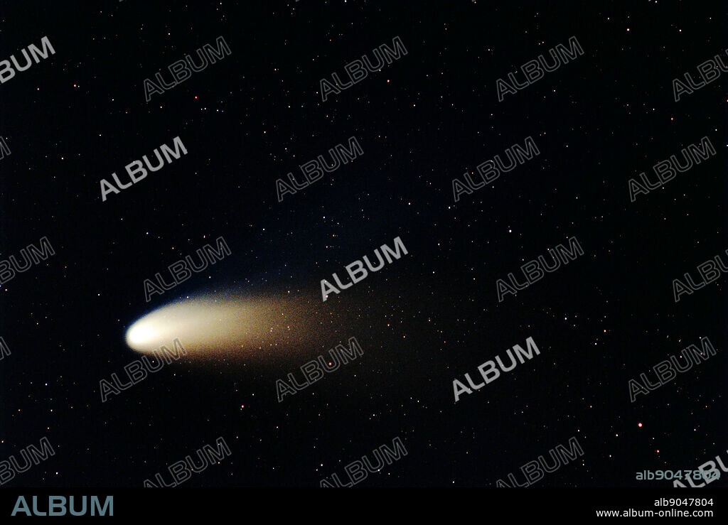 The Dust and Ion Tails of Comet Hale-Bopp. In 1997, Comet Hale-Bopp's intrinsic brightness exceeded any comet since 1811. Since it peaked on the other side of the Earth's orbit, however, the comet appeared only brighter than any comet in two decades. Visible above are the two tails shed by Comet Hale-Bopp. The blue ion tail is composed of ionized gas molecules, of which carbon monoxide particularly glows blue when reacquiring electrons. This tail is created by the particles from the fast solar wind interacting with gas from the comet's head. The blue ion tail points directly away from the Sun.