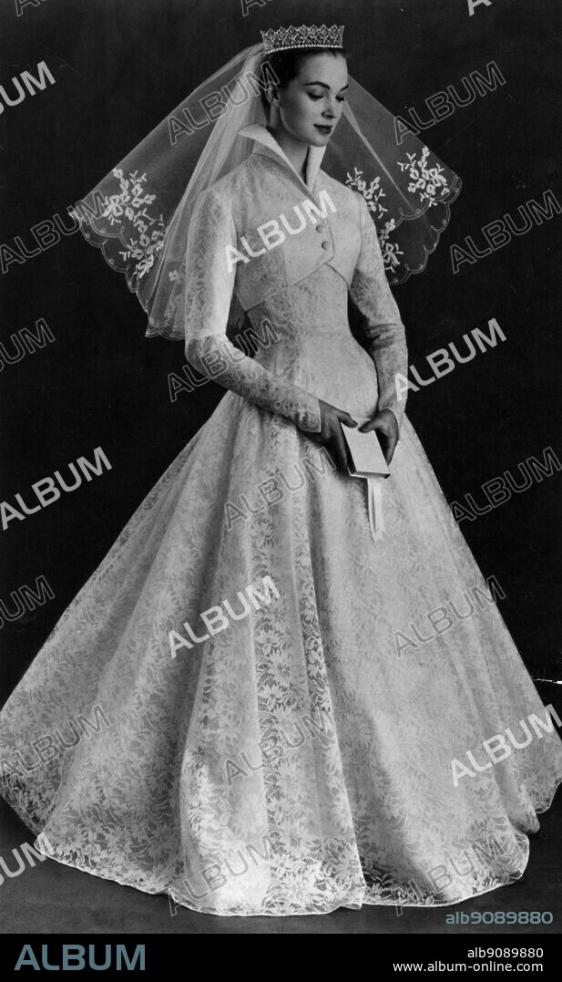 Witchcraft lace. The jacket of this wedding dress is removable and the dress becomes an evening gown.