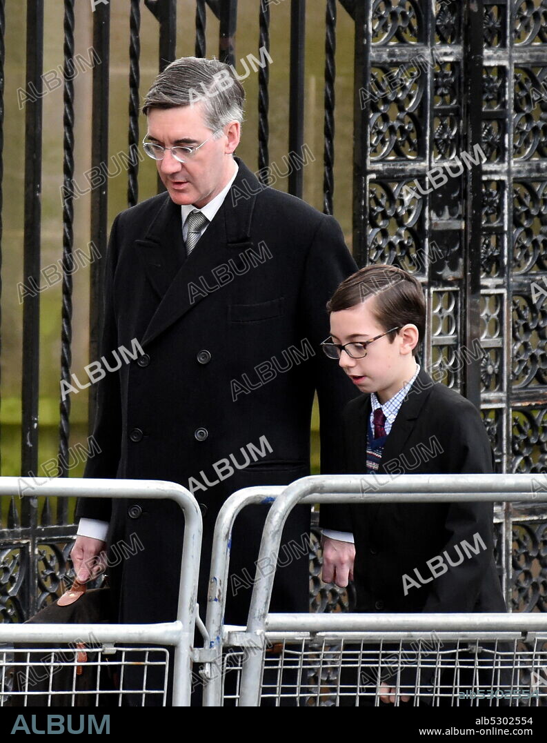 Photograph of Jacob Rees-Mogg with his son, arriving for the state opening of Parliament. Jacob William Rees-Mogg (1969-) a British politician serving as Leader of the House of Commons and Lord President of the Council since 2019, and who has served as Member of Parliament for North East Somerset since 2010.