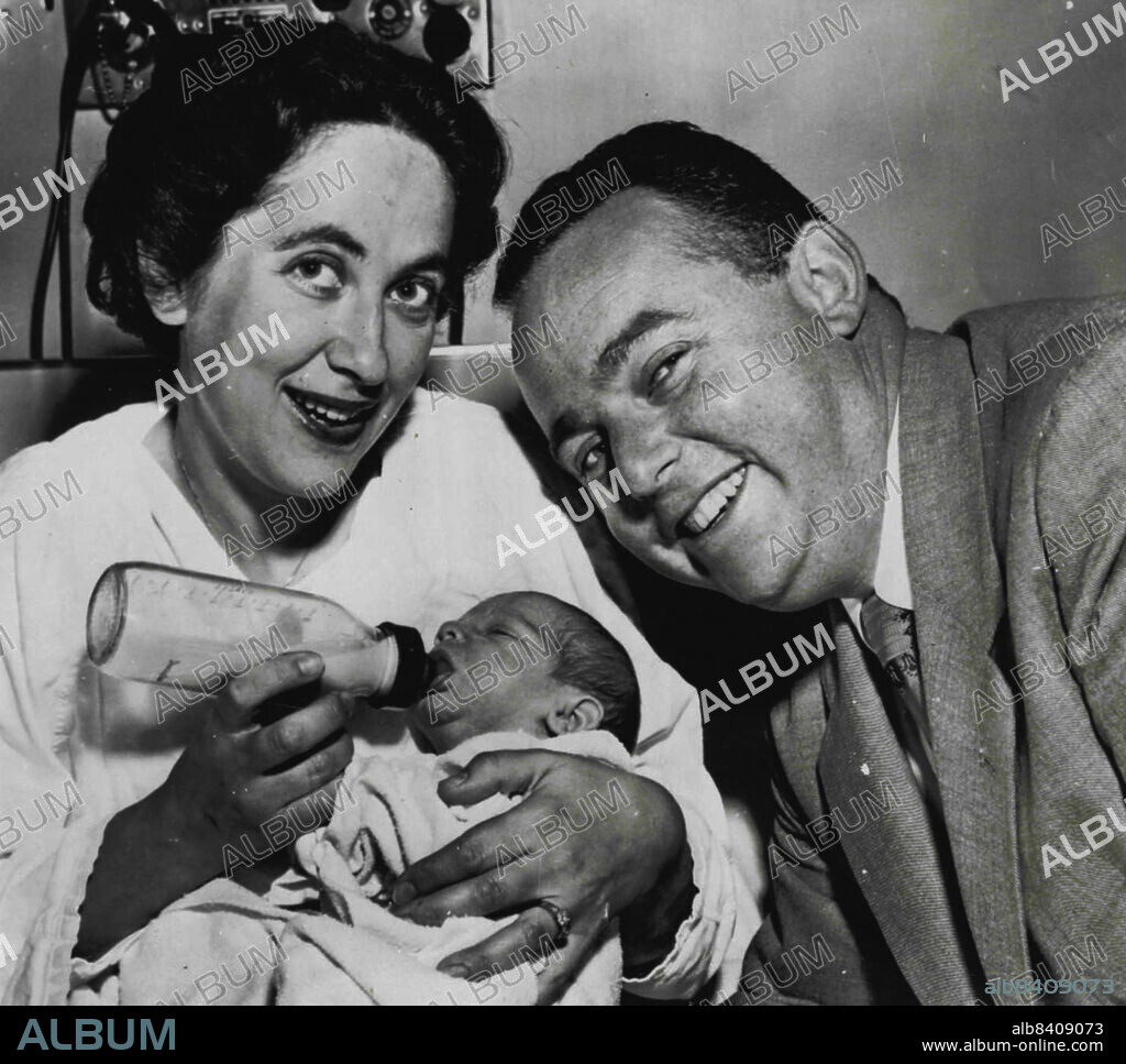 Kidnapped Infant Returned To Hospital -- Dr. Sanford Marcus smiles happily as his wife, Hanna, feeds their son, Robert, after his return to Mt. Zion hospital here Sept, 28. The baby was taken from the hospital's nursery Sept. 19 and recovered in Stockton, Calif., early today. Mrs. Betty Benedicto, 27, is being held here in connection with the kidnapping. September 29, 1955. (Photo by AP Wirephoto).